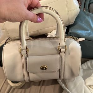 Gently used mini barrel bag in chalk. Includes shoulder strap and dust bag